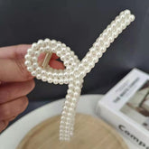 Pearl Bow Hair Clip – Elegant Ribbon Style showcasing a glossy pearl finish and stylish bow design, perfect for hairstyles.